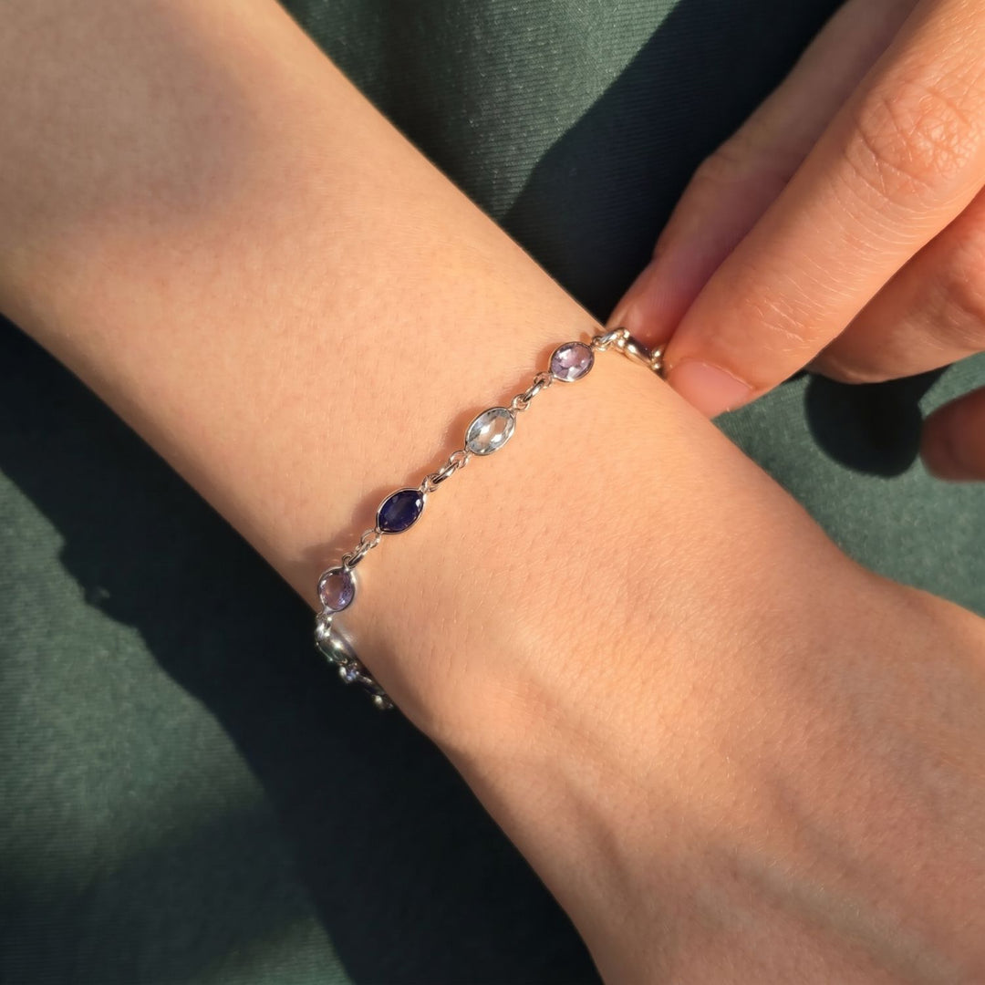 Shades of blue crystal set along a sterling silver bracelet